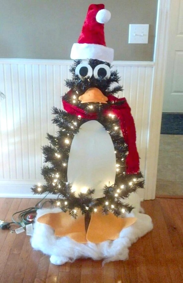 Black Christmas tree decorated to look like a penguin.